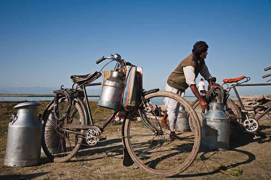  Farmers bringing ther milk cans to a distirbution point at the shore of the Brahmaputra river